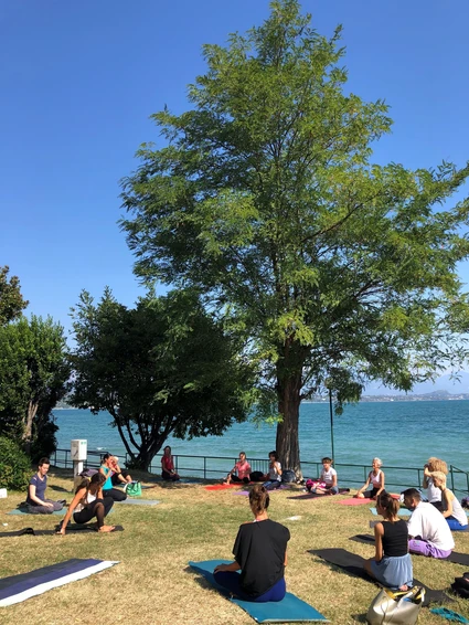 Yoga group lesson outdoors with a view on Lake Garda 0